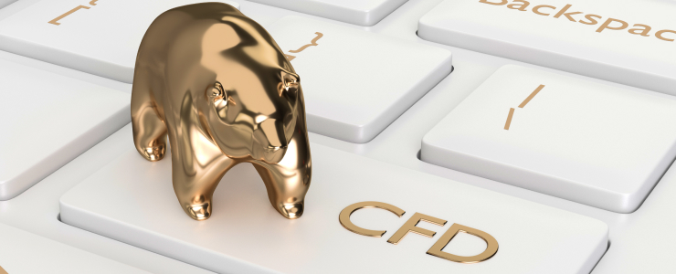 Golden bull figurine on a keyboard, with the CFD symbol prominently displayed nearby.