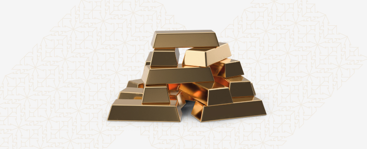 A stack of gold bars arranged neatly on a white background, symbolizing wealth and precious metals.