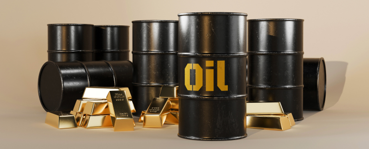 Barris de ouro e petróleo com a palavra «petróleo» impressa, ilustrando os principais ativos no comércio de commodities.