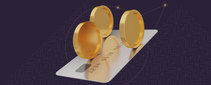 A credit card with two gold coins placed on top, representing currency and payment methods.