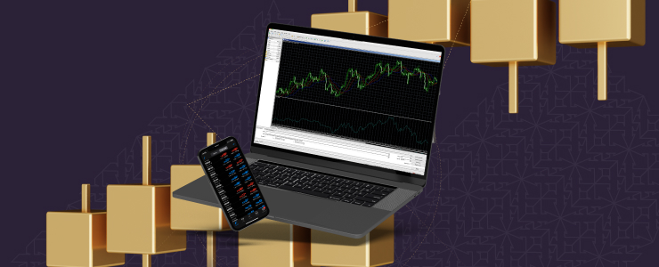 A laptop next to a gold bar displaying a financial chart, representing trading on MetaTrader 4.
