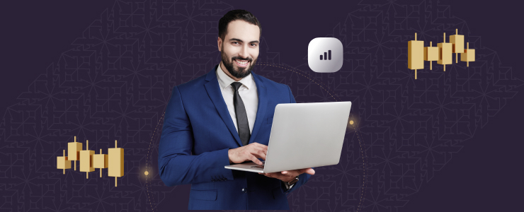 A man in a blue suit smiles while using a laptop against a dark background with financial graph icons, representing global trading indices in a professional setting.